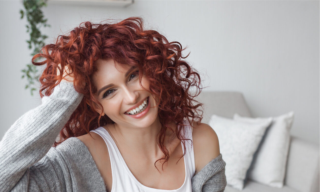 Red hair young girl holding head